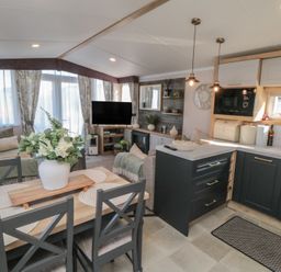 A living room with a sofa and dining area at 19 Finch