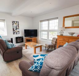 A living room with a sofa and television at Apartment 3 in Newquay