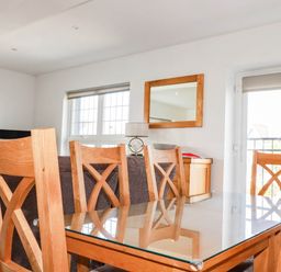 A dining area with a table and chairs at Apartment 3 in Newquay
