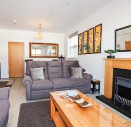A living room with a sofa and coffee table at Apartment 1 in Newquay