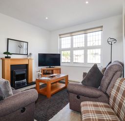 A living room with a sofa and coffee table at Apartment 1 in Newquay