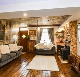 A living room with a sofa and fireplace at Severnwolf House in Gloucester