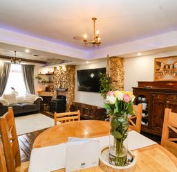 A dining room with a table and chairs at Severnwolf House in Gloucester