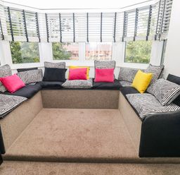 A snug area with seating and cushions at 21 Ferrara Square Swansea