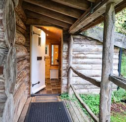 An entrance with a door and pathway at Thimble Lodge in Gunnislake