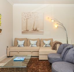 A living room with a sofa and armchair at 1 Embankment House in Dartmouth
