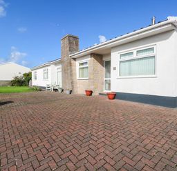 A house with a front porch and garden at 24 Little Castle Grove in Hubberston