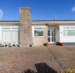 An exterior view of a house with a chimney and potted plants at 24 Little Castle Grove Hubberston