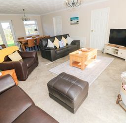 A living room with seating and a dining area at 24 Little Castle Grove, Hubberston
