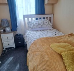 A bedroom with a single bed and a nightstand at Chapel Farm Holiday Park No 6 Bunnies View Appleby-in-Westmorland