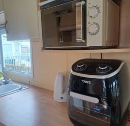 A kitchen with a microwave and air fryer at Chapel Farm Holiday Park No 6 Bunnies View Appleby-in-Westmorland