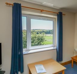 A living room with a window and a table at Plover in Kingsteignton