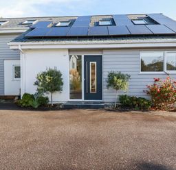 An exterior view of a house with solar panels at Harber Rise in Carlyon Bay