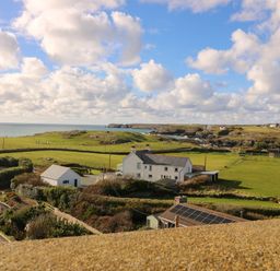 A view of the ocean and houses at Llywelyn in Trearddur Bay