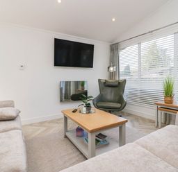 A living room with a sofa and coffee table at Thirlmere Scar in Troutbeck Bridge