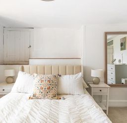 A bedroom featuring a bed, bedside tables and a mirror at The Old Barn in Manchester