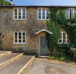 A house with ivy and a front door at The Old Cottage in an unspecified location