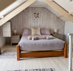 A bedroom with a bed and nightstands at The Old Barn in Manchester