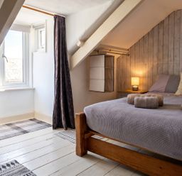 A bedroom with a bed and window at The Old Barn in Manchester