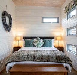 A bedroom with a bed and bedside table at the property