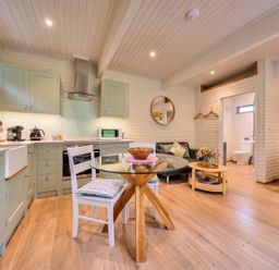 A kitchen with cabinets and a dining area at the property in unspecified location