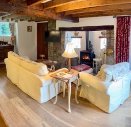 A living room with a sofa, lamp, and fireplace at The Old Barn in Manchester