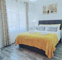 A bedroom with a bed and side tables at 