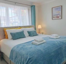 A bedroom with a bed and nightstand at The Old Barn in Manchester