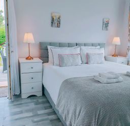 A bedroom with a bed and bedside tables at The Old Barn in Manchester