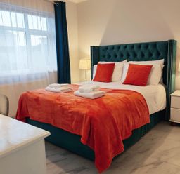 A bedroom with a bed and nightstands at 