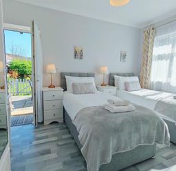 A bedroom with two beds and lamps at the property
