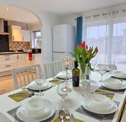 A dining room with a table set for dinner at the property in 