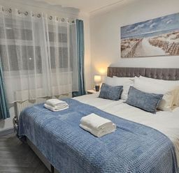 A bedroom with a bed and bedside lamp at The Old Barn in Manchester
