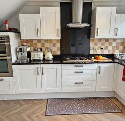 A kitchen with appliances and cabinets at the property