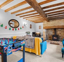 A snug with a foosball table and fireplace at the property