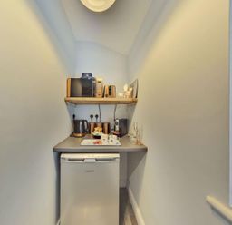 A kitchen with appliances and storage at 