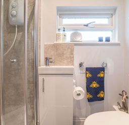 A bathroom with shower and sink at The Old Barn in Manchester