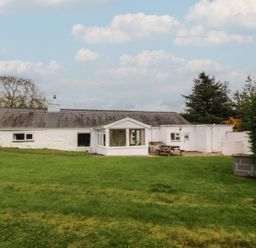 A house with grass and trees at Bryn Eithin in Penygroes