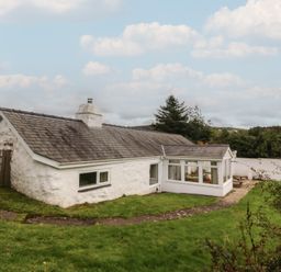 An exterior view of a house with garden at Bryn Eithin in Penygroes
