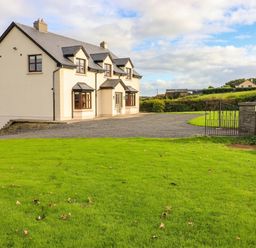 A house with a driveway and grass at Wild Atlantic Ferry View, Kilrush, County Clare