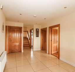 A hallway with doors and a staircase at Wild Atlantic Ferry View in Kilrush, County Clare
