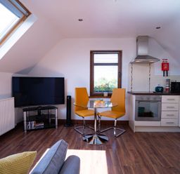 A kitchen with a dining table and chairs at Limavady Cherry Tree Apartment, Sleeps 2 and Parking Limavady