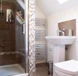 A bathroom with a shower, sink, and toilet at Limavady Cherry Tree Apartment, Sleeps 2 and Parking, Limavady