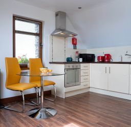 A kitchen with a table and chairs at Limavady Cherry Tree Apartment, Sleeps 2 and Parking in Limavady