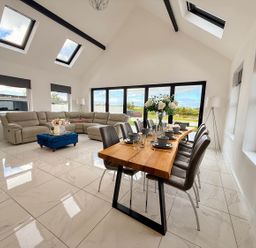 A living room with a sofa and dining area at Jeannies retreat at little lake fb
