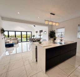 An open plan kitchen and dining area with a kitchen island at Jeannies retreat at little lake fb