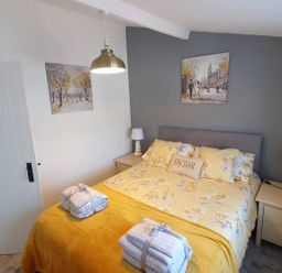 A bedroom with a bed and bedside tables at 1 Bedroom Apartment with Sea View in Mevagissey