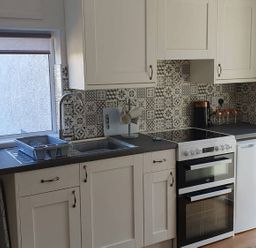 A kitchen with sink, stove, and refrigerator at 1 Bedroom Apartment with Sea View in Mevagissey