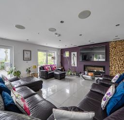 A living room with sofas and a television at 5 Bed House, Sleeps 14 with Hot Tub and Bar in Tavistock