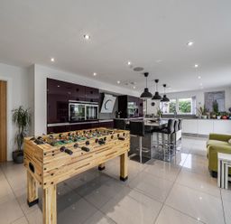 A kitchen with a foosball table and island seating at 5 Bed House, Sleeps 14 with Hot Tub and Bar Tavistock